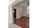 Living room featuring a large archway, wood floors, neutral paint, and natural light at 10134 Reflection Brook Ave, Las Vegas, NV 89148