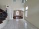 Open floor plan showing tile floors, decorative wrought iron staircase, and hardwood flooring at 10134 Reflection Brook Ave, Las Vegas, NV 89148