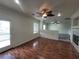 Open living room with a ceiling fan, fireplace, and glass exterior door at 10134 Reflection Brook Ave, Las Vegas, NV 89148