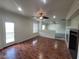 Living room with a ceiling fan, fireplace, and glass exterior door at 10134 Reflection Brook Ave, Las Vegas, NV 89148