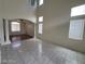 Open floor plan showing living area with tile floors flowing into a room with hardwood flooring at 10134 Reflection Brook Ave, Las Vegas, NV 89148