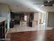 Open concept living room with dark wood floors and abundant natural light at 10134 Reflection Brook Ave, Las Vegas, NV 89148