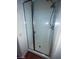 Enclosed glass shower featuring white tiles and a shower head at 10134 Reflection Brook Ave, Las Vegas, NV 89148