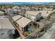 Aerial view of single-Gathering homes showcasing lush desert landscaping and tile roofs at 10532 Beachwalk Pl, Las Vegas, NV 89144