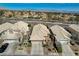 An aerial view showcasing a residential neighborhood with desert landscaping and mountain views at 10532 Beachwalk Pl, Las Vegas, NV 89144