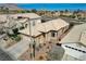 An aerial view featuring a well-maintained home with a tiled roof, desert landscaping, and neighborhood at 10532 Beachwalk Pl, Las Vegas, NV 89144