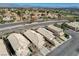 Scenic aerial view of a residential area featuring neat rows of houses, streets, and distant mountains at 10532 Beachwalk Pl, Las Vegas, NV 89144