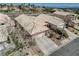 Close aerial view of a single-Gathering home with a two-car garage and desert landscaping at 10532 Beachwalk Pl, Las Vegas, NV 89144