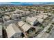 Bird's-eye view of a neighborhood highlighting homes with tile roofs and desert landscaping at 10532 Beachwalk Pl, Las Vegas, NV 89144