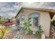 Inviting backyard featuring an outdoor dining set, lush plants, and stylish decor elements at 10532 Beachwalk Pl, Las Vegas, NV 89144
