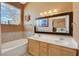 Bathroom with double sink vanity and a large mirror reflecting the bedroom at 10532 Beachwalk Pl, Las Vegas, NV 89144
