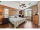 Comfortable bedroom features a ceiling fan, warm wall color, and a large window providing ample natural light at 10532 Beachwalk Pl, Las Vegas, NV 89144