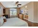 Inviting bedroom with a ceiling fan and a large window offering plenty of natural light at 10532 Beachwalk Pl, Las Vegas, NV 89144