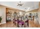 Inviting dining area with wood floors, modern lighting fixture and open access to a spacious kitchen at 10532 Beachwalk Pl, Las Vegas, NV 89144
