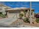 Charming single-story home featuring desert landscaping, a two-car garage, and a neutral color palette at 10532 Beachwalk Pl, Las Vegas, NV 89144