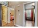 Hallway with access to bedroom and bathroom, featuring hard wood floors and neutral walls at 10532 Beachwalk Pl, Las Vegas, NV 89144