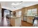 Well-lit kitchen with granite countertops, stainless steel appliances, and a breakfast bar island at 10532 Beachwalk Pl, Las Vegas, NV 89144