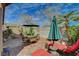 Charming outdoor patio area with a dining set, lounge chairs, and shade, perfect for entertaining at 10532 Beachwalk Pl, Las Vegas, NV 89144