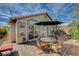 A covered patio, complete with a table and chairs, offering a cozy outdoor dining space at 10532 Beachwalk Pl, Las Vegas, NV 89144