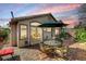 Inviting patio with a table, chairs, lush plants, and desert landscaping for outdoor enjoyment at 10532 Beachwalk Pl, Las Vegas, NV 89144