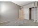 Carpeted bedroom with neutral walls, closet, and attached ladder/shelving feature at 1101 Coral Desert Drive, Las Vegas, NV 89123