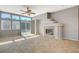 Living room featuring tile flooring, a ceiling fan, fireplace, and views of the pool at 1101 Coral Desert Drive, Las Vegas, NV 89123