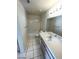 Simple bathroom with a tub-shower combo, vanity, and tiled floor at 1213 Daytona Ln, Las Vegas, NV 89117