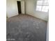 A tidy bedroom with a window, neutral walls, and carpeted floors at 1213 Daytona Ln, Las Vegas, NV 89117