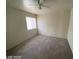 A simple bedroom featuring neutral walls, carpet, and a ceiling fan at 1213 Daytona Ln, Las Vegas, NV 89117