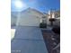 Inviting single-story home with desert landscaping and a spacious driveway leading to a two-car garage at 1213 Daytona Ln, Las Vegas, NV 89117