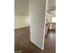 Hallway featuring wood-style tile flooring leading to a kitchen with modern appliances at 1213 Daytona Ln, Las Vegas, NV 89117
