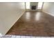 Open living room area with wood-style tile flooring and a decorative fireplace at 1213 Daytona Ln, Las Vegas, NV 89117