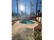 Private backyard oasis featuring a sparkling pool with a rock waterfall and lush palm trees at 1213 Daytona Ln, Las Vegas, NV 89117