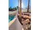 Secluded backyard pool area with a custom rock waterfall feature and tropical palm tree accents at 1213 Daytona Ln, Las Vegas, NV 89117