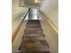 Carpeted staircase with wooden handrails leading to the upper level of the home at 1213 Daytona Ln, Las Vegas, NV 89117