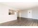 Living room showcasing laminate flooring, complemented by a partial view into the adjacent kitchen at 1405 Vegas Valley Dr # 306, Las Vegas, NV 89169