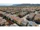 Expansive aerial view of a vibrant residential neighborhood nestled against a backdrop of majestic mountains and clear blue skies at 1908 Morro Vista Dr, Las Vegas, NV 89135