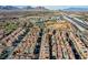 Panoramic aerial shot showing residential development near a major highway, with mountains in the background at 1908 Morro Vista Dr, Las Vegas, NV 89135
