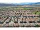 Wide aerial shot of a vast residential area with a golf course, set against a mountain range and a clear sky at 1908 Morro Vista Dr, Las Vegas, NV 89135