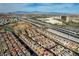 Extensive aerial view capturing a community near a highway and business area, with mountains in the distance at 1908 Morro Vista Dr, Las Vegas, NV 89135