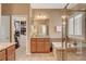 Spacious bathroom featuring a vanity, a soaking tub, and walk-in closet access at 1908 Morro Vista Dr, Las Vegas, NV 89135