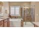 Well-lit bathroom with a soaking tub, a glass enclosed shower and elegant tile work at 1908 Morro Vista Dr, Las Vegas, NV 89135