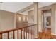 Second floor hallway with wood railing, neutral color scheme, and an open design at 1908 Morro Vista Dr, Las Vegas, NV 89135