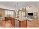 Open kitchen with granite countertop island bar and view of the living room and dining area at 1908 Morro Vista Dr, Las Vegas, NV 89135