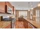 Kitchen with granite countertops, stainless steel appliances, and an adjacent dining area at 1908 Morro Vista Dr, Las Vegas, NV 89135