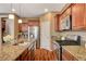 Kitchen featuring granite counters, stainless steel appliances, and wood-look flooring at 1908 Morro Vista Dr, Las Vegas, NV 89135