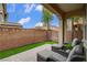 Relaxing patio with seating, well-manicured lawn, and privacy wall, perfect for outdoor enjoyment at 1908 Morro Vista Dr, Las Vegas, NV 89135