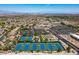 Beautiful aerial view of community tennis courts, clubhouse, and distant city skyline at 1992 Fort Halifax St, Henderson, NV 89052
