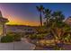 Tranquil backyard landscape featuring lush tropical plants, mountain views, and a pathway to the patio at 1992 Fort Halifax St, Henderson, NV 89052