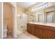 Bathroom featuring a double sink vanity and a tiled shower stall with a built-in seat at 1992 Fort Halifax St, Henderson, NV 89052